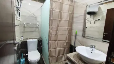 a bathroom with a white toilet and a sink at Stylish Sunny Central 1BR in Hurghada