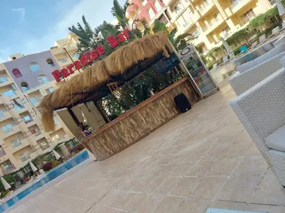 a large planter with red flowers on top of a building at Florenza Khamsin Sea front in Hurghada