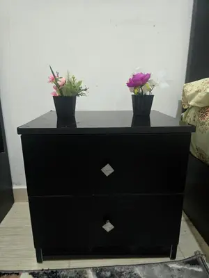 two flowers on top of a black dresser at Florenza Khamsin Sea front in Hurghada