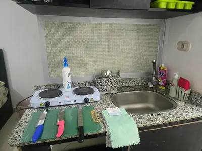 a kitchen counter with a sink and a bottle on it at Florenza Khamsin Sea front in Hurghada