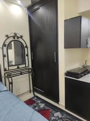 a black door in a room with a bed and a sink at Florenza Khamsin Sea front in Hurghada