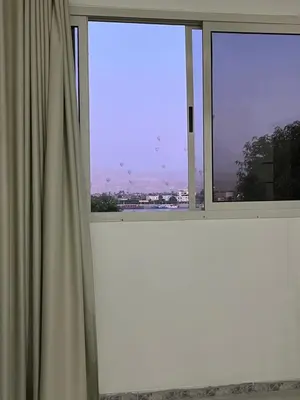 a window with a view of a city at Tut Apartment in Luxor
