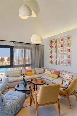 a living room with a couch and tables and chairs at VESTA - El Gouna Residence in Hurghada