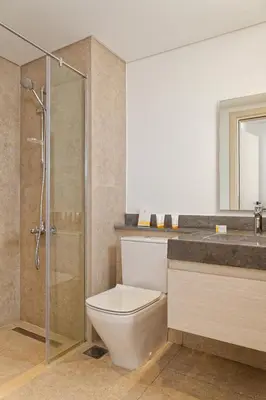 a bathroom with a toilet and a shower and a sink at VESTA - El Gouna Residence in Hurghada