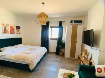 a bedroom with a bed and a tv in it at Aqua Infinity in Hurghada
