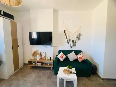 a living room with a green couch and a table at Aqua Infinity in Hurghada