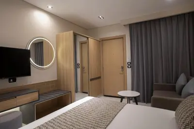 a hotel room with a bed and a television at The D9 Luxury Suites - Hurghada in Hurghada