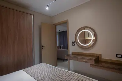 a bedroom with a large mirror and a bed at The D9 Luxury Suites - Hurghada in Hurghada