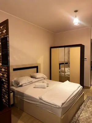 a bedroom with a large bed with a large mirror at Aldau heights Hurghada in Hurghada