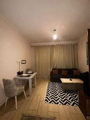 a living room with a couch and a table at Aldau heights Hurghada in Hurghada