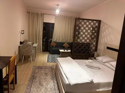 a bedroom with a bed and a living room at Aldau heights Hurghada in Hurghada