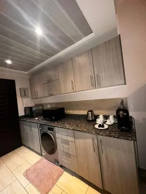 a kitchen with a washer and dryer on a counter at Aldau heights Hurghada in Hurghada