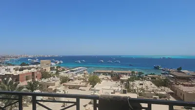 a view of a beach with boats in the water at Sea view 3 bedrooms apartment 06 in Hurghada
