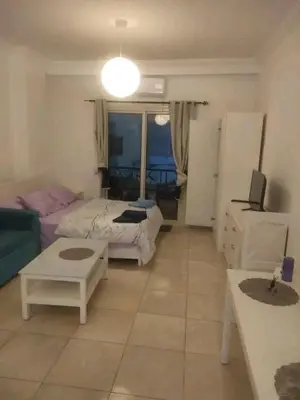a living room with a bed and a couch at Sheraton Plaza in Hurghada