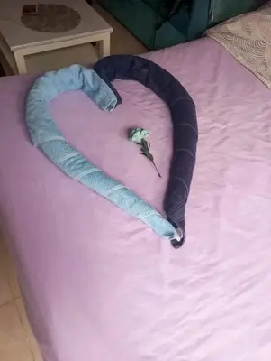 a heart made out of a blue towel on a bed at Sheraton Plaza in Hurghada