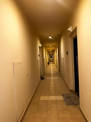 an empty hallway with a long hallway with white walls at Aldau heights Hurghada in Hurghada