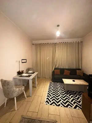 a living room with a couch and a table at Aldau heights Hurghada in Hurghada