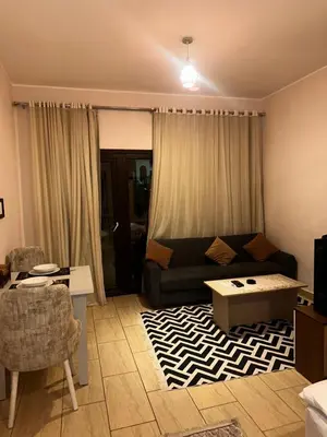 a living room with a couch and a table at Aldau heights Hurghada in Hurghada