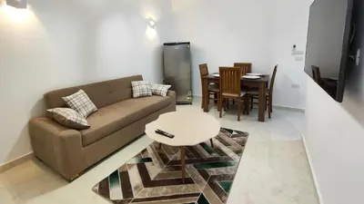 a living room with a couch and a table at Comfort quiet central new flat in Hurghada