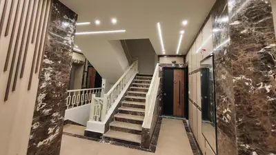 a hallway with stairs in a building with marble walls at Comfort quiet central new flat in Hurghada