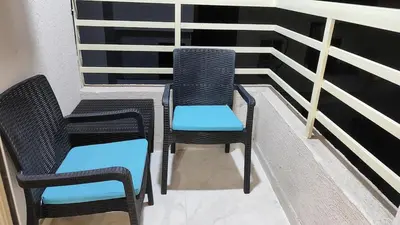 two chairs and two chairs sitting on a balcony at Comfort quiet central new flat in Hurghada