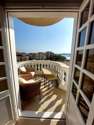 a view of a balcony with a table and chairs at Antique apartment with sea view in Hurghada