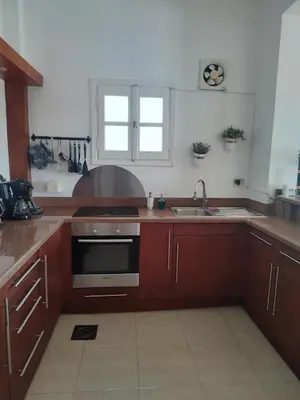 a kitchen with a sink and a stove top oven at Antique apartment with sea view in Hurghada