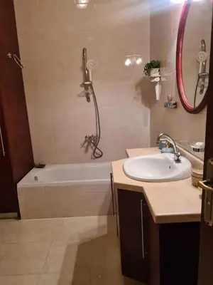 a bathroom with a tub and a sink and a shower at Antique apartment with sea view in Hurghada