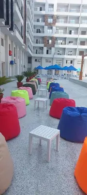 a row of tables with colorful cushions in a building at Golden Tiba in Hurghada