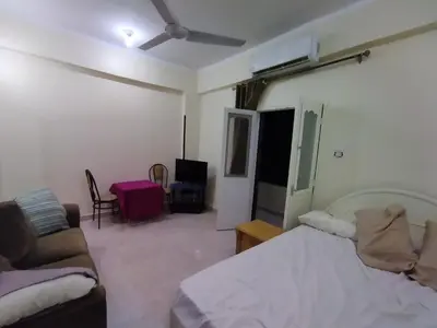 a living room with a bed and a couch at Peaceful Private Studio Steps from Luxor in Luxor