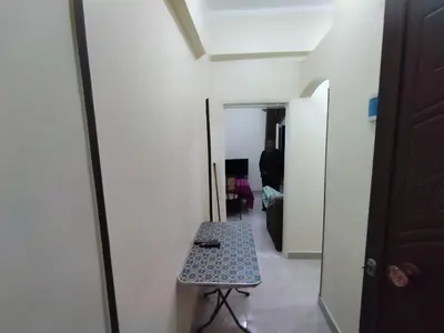 a room with a table and a hallway with a door at Peaceful Private Studio Steps from Luxor in Luxor