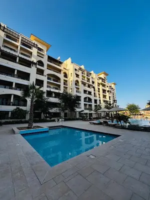 a swimming pool in front of a large apartment building at Prime Square Aldau Heights in Hurghada
