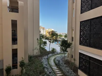 a walkway between two buildings in a city at Prime Square Aldau Heights in Hurghada