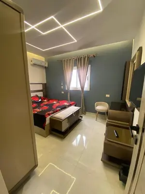 a bedroom with a bed and a chair in it at Private 3 bedroom apartment in Hurghada