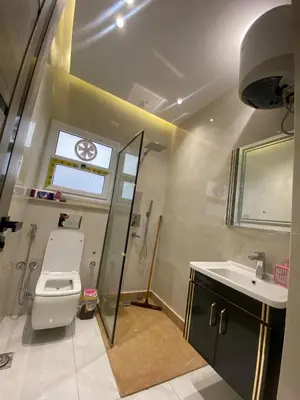 a bathroom with a toilet and a sink and a window at Private 3 bedroom apartment in Hurghada