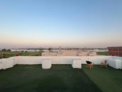 a view of a rooftop with white walls and chairs at King Nile Luxor in Luxor