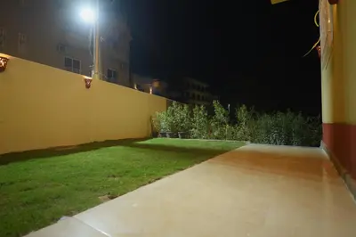 a yard at night with a light on a building at King Nile Luxor in Luxor