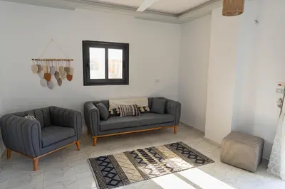 a living room with two chairs and a couch at Sultan's Suite-Chill Out Roof Terrace-3 Bedrooms in Hurghada