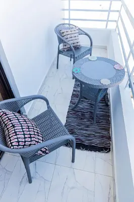 two chairs and a table on a balcony at Sultan's Suite-Chill Out Roof Terrace-3 Bedrooms in Hurghada