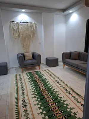 a living room with two couches and a rug at Sultan's Suite-Chill Out Roof Terrace-3 Bedrooms in Hurghada