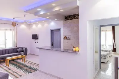 a living room with a couch and a counter at Sultan's Suite-Chill Out Roof Terrace-3 Bedrooms in Hurghada