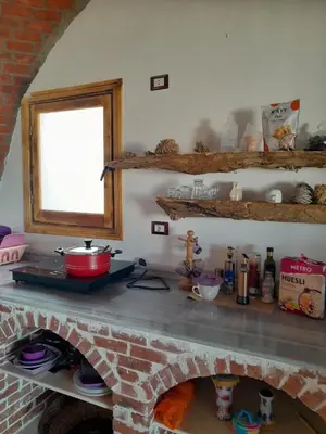 a kitchen with a stone counter top with a brick oven at 3-Bed Sleeps 6 with Sea View & Free Parking in Hurghada