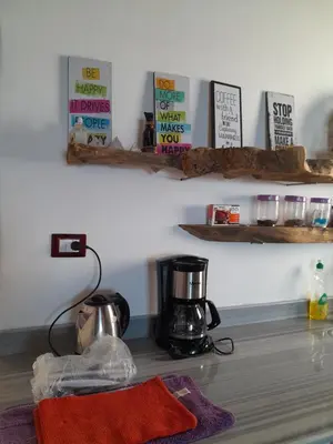 a kitchen with a coffee maker and books on the wall at 3-Bed Sleeps 6 with Sea View & Free Parking in Hurghada
