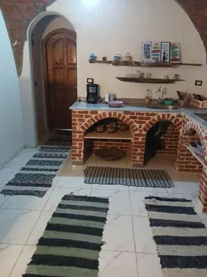 a living room with a brick fireplace and some rugs at 3-Bed Sleeps 6 with Sea View & Free Parking in Hurghada