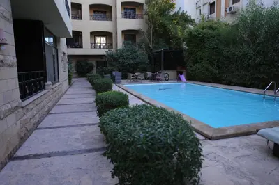 a swimming pool in front of a building at Casa Hurghada in Hurghada