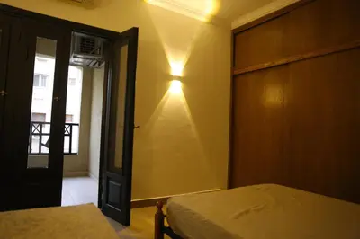 a bedroom with a bed and a light on the wall at Casa Hurghada in Hurghada