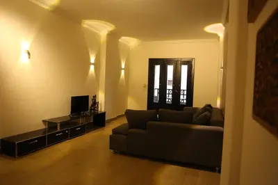 a living room with a couch and a television at Casa Hurghada in Hurghada