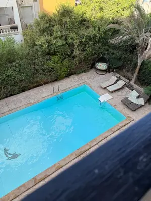 a large blue swimming pool in a yard at Casa Hurghada in Hurghada