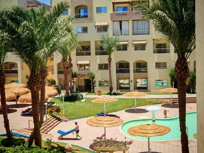 a view of a resort with palm trees and a pool at Studio in Nubia Aqua Beach Twin Room in Hurghada in Hurghada