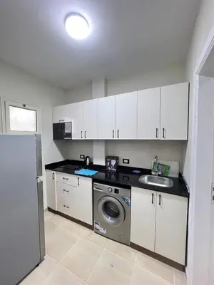 a kitchen with a washing machine and a sink at Studio in Nubia Aqua Beach Twin Room in Hurghada in Hurghada